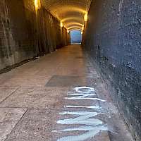 A subway tunnel with On Inn written on the floor in flour.